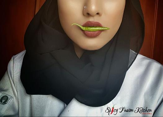 Botswana influencer Zainab Dokrat holding a pepper in her mouth