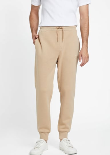 A man wearing tan joggers