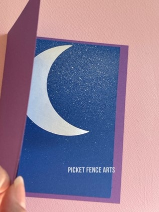 purple and blue greeting card with a white moon