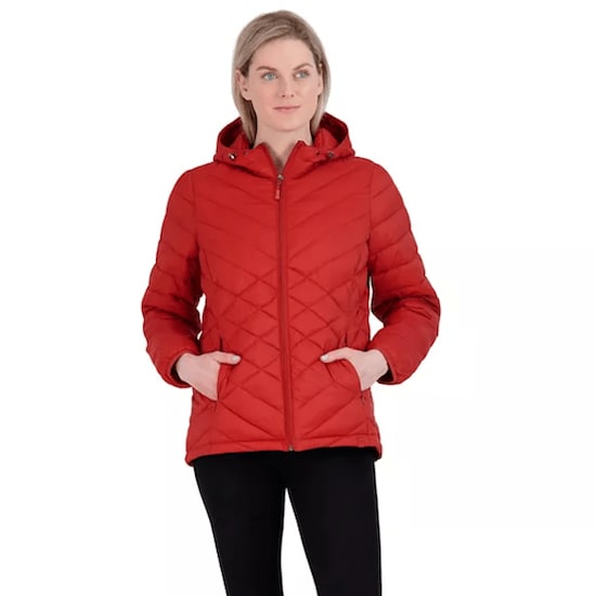 A woman wearing an Autumn Red ZeroXposur Brooke Packable Puffer Jacket with black pants 