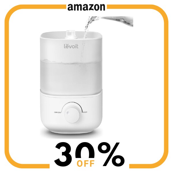 A white humidifier with water being poured into it