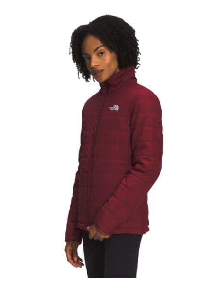 Model wearing a burgundy North Face reversible fleece