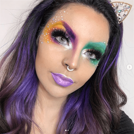Blogger Azul wearing gem cat ears and purple and green makeup on face