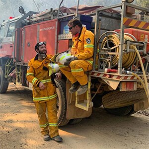 Firefighters resting on truck