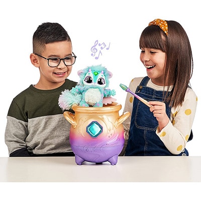 Two children playing with the Magic Mixies Magical Misting Cauldron Toy