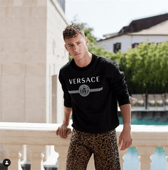 Israeli model and influencer Barak Shamir posing in Versace