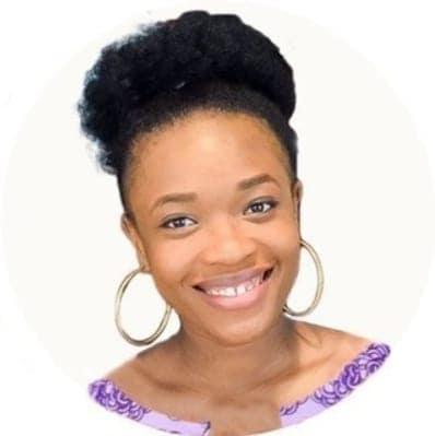 Adaobi Okonkwo, Nigerian influencer and creative director of Dobby's Signature, smiling in hoop earrings and a purple shirt
