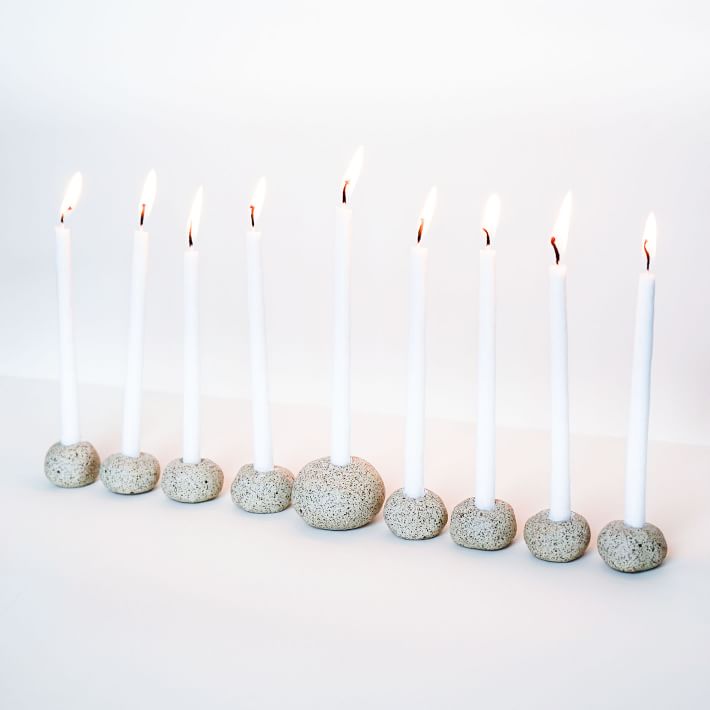 stone menorah with lit candles