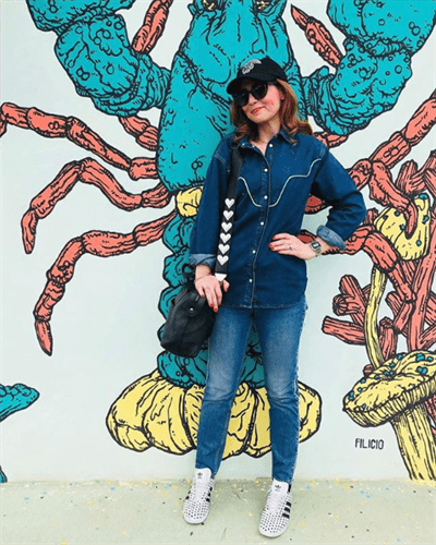 Influencer Valentina Donatelli posing in front of a lobster wall mural