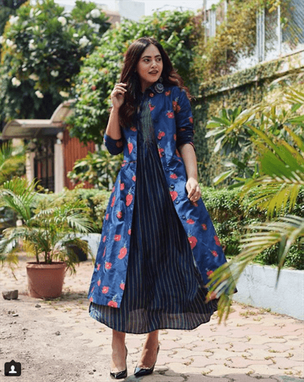 Blogger Aayushi Bangur Sahu wearing navy and white striped dress with purple and red flower jacket