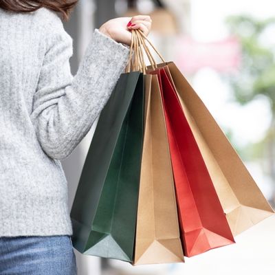 image of a woman with red nails holding several shopping bags