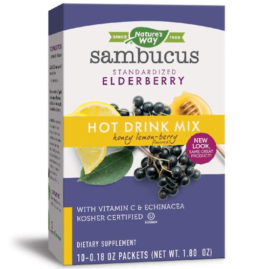A purple, yellow, and white box of Nature’s Way Sambucus Soothing Elderberry Hot Drink Mix with lemons, elderberries, and honey in front
