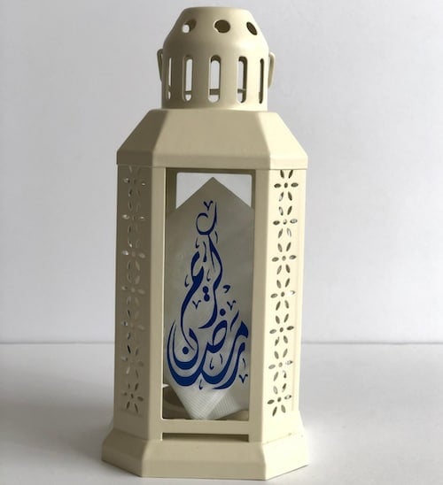 An ivory colored Personalized Ramadan Lantern with blue symbols in the center