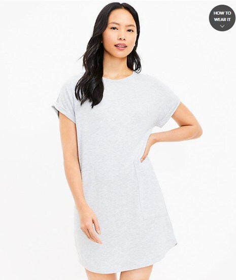A model with black hair posing in the light gray pocket shift dress from Loft