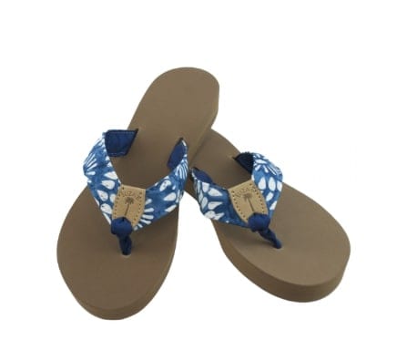 A pair of flip flops with tie dye strap