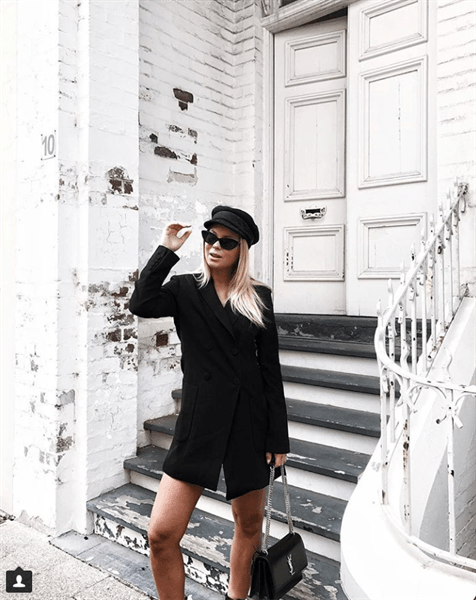 Influencer Victoria Tornegren outside white building wearing all black