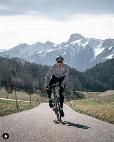 Cyclist and influencer Guilhem Lacaze riding his bike in the mountains
