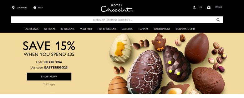 A screenshot of Hotel Chocolat’s homepage that promotes their Easter sale and code on the left, and a selection of milk, dark, and white chocolate pieces on the right