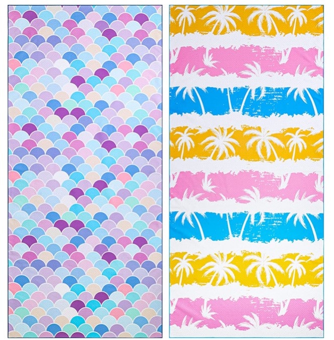 An image showing a set of laid-out towels. The one on the left is mermaid-inspired and has gills in pink, purple, and blue shades, and the one on the right has pink, blue, and yellow rows separated with white lines and there’s white palm prints all over.