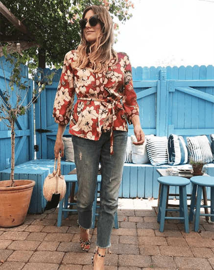 Influencer Sofia Lascurai weraing floral top and jeans with frill