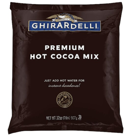 A dark brown bag of Ghirardelli Premium Hot Cocoa Mix featuring the blue and white logo and white letters in the middle top of the bag