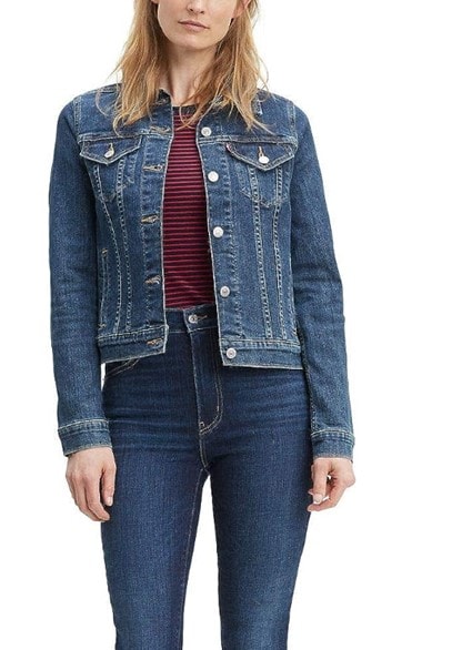Model wearing a classic Levi’s denim jacket paired with jeans and a red and black striped blouse