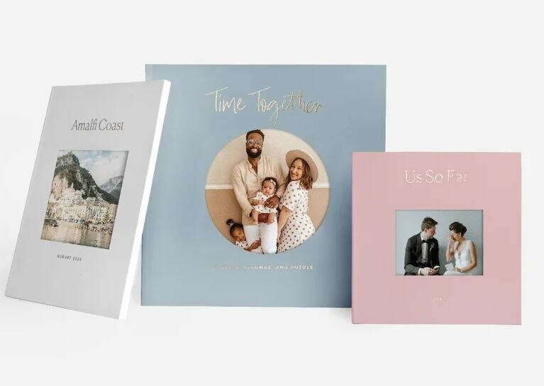 three photo albums, gray depicting the amalfi coast, teal depicting a family that reads our time together, and a pink album with a couple in front