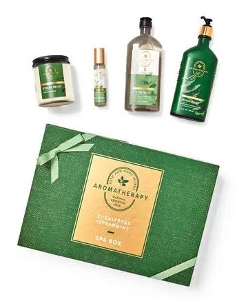 green spa box from aromatherapy with four products - a candle, essential oil mist, body wash, and lotion in the eucalyptus spearmint scent