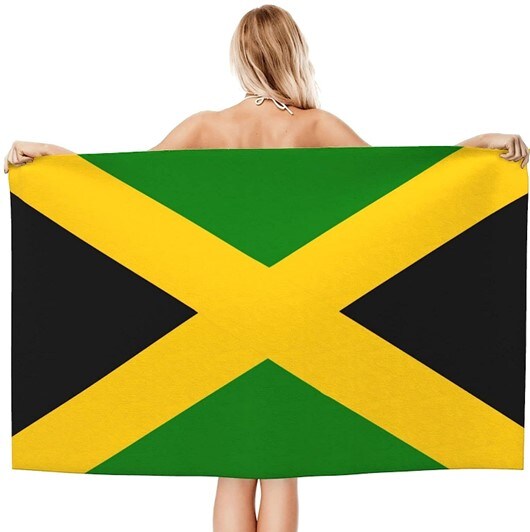 Woman holding a Jamaican flag beach towel