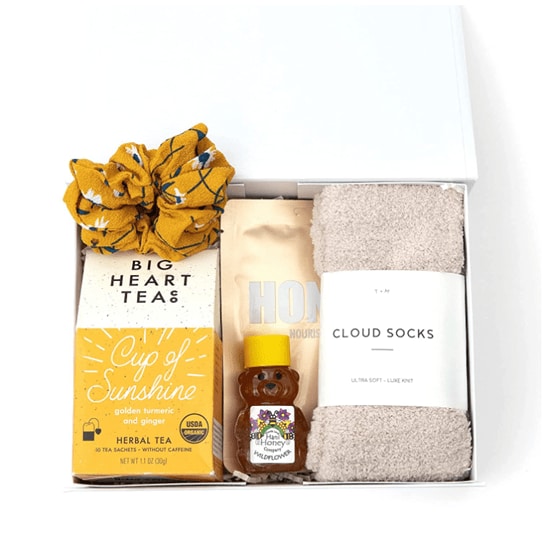 -piece care package for women with socks, tea, honey, honey mask and a scrunchie