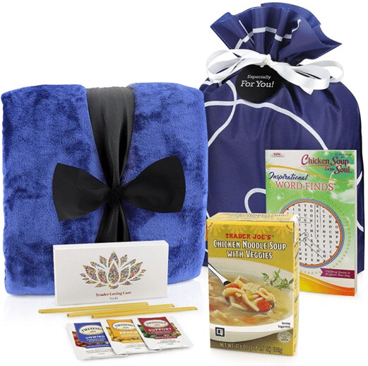 Care package for men including a blue blanket, soup packages, herbal tea with honey straws and a crossword puzzle