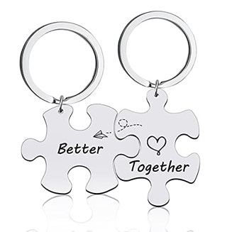 Two silver puzzle-shaped keychains with engraved words