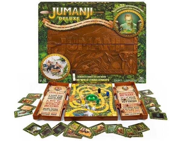 The Jumanji Deluxe game board box and its components, including cards, timers, and tokens in front of it
