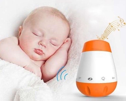Image of sleeping infant with orange and white baby soother sleep sound machine