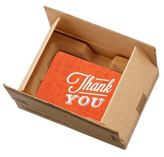 An orange Amazon gift card with a “Thank You” note on it written in white font and packed in a small cardboard box