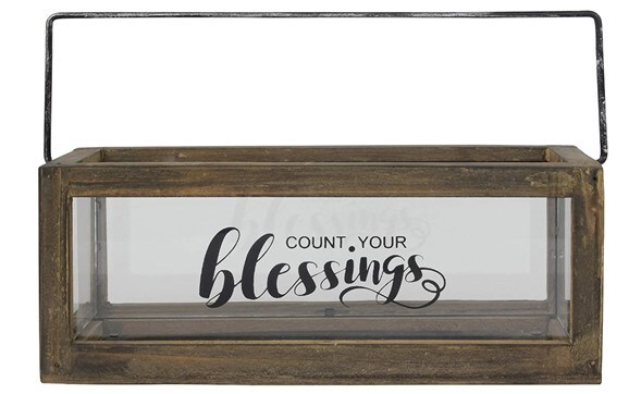 Rectangle-shaped glass box with a “Count Your Blessings” writing, a dark wooden frame and a black metal holder
